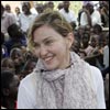 Madonna with her Malawian adopted children, David and Mercy sit among Malawian children during a visit to Mkoko Primary School 