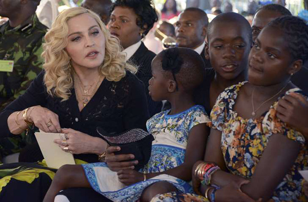 Madonna sits with her adopted children Stella, David and Mercy, at the opening of The Mercy James Institute for Pediatric Surgery and Intensive Care, located at the Queen Elizabeth Central Hospital in the city of Blantyre, Malawi, Tuesday, July 11, 2017.