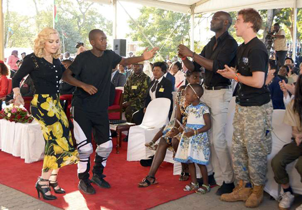 Madonna and David dance at the opening of the Mercy James Center in Malawi