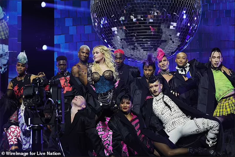 Madonna on her Celebration Tour, with Nicholas Huchard on her right
